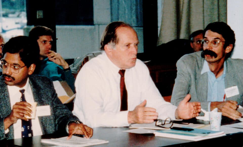 Woodwell scientists briefing colleagues at a conference table